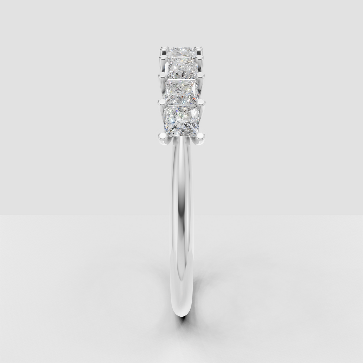 Princess stone eternity band with four-prong detailing