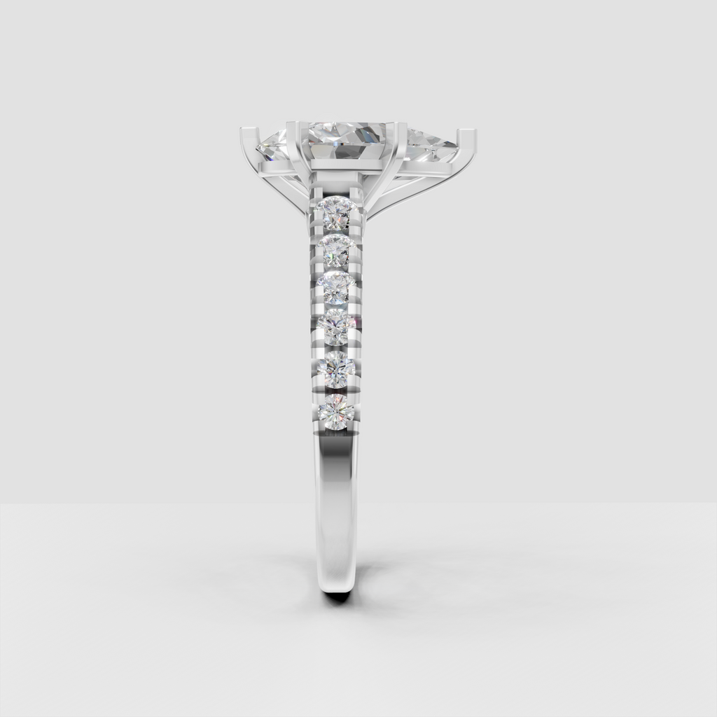 Luxury pear cut diamond engagement ring with polished gold band and sparkling round accent stones.
