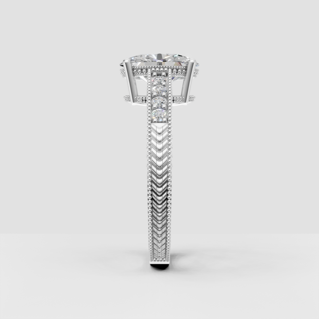 Oval diamond ring featuring ornate engraved chevron band and milgrain accents