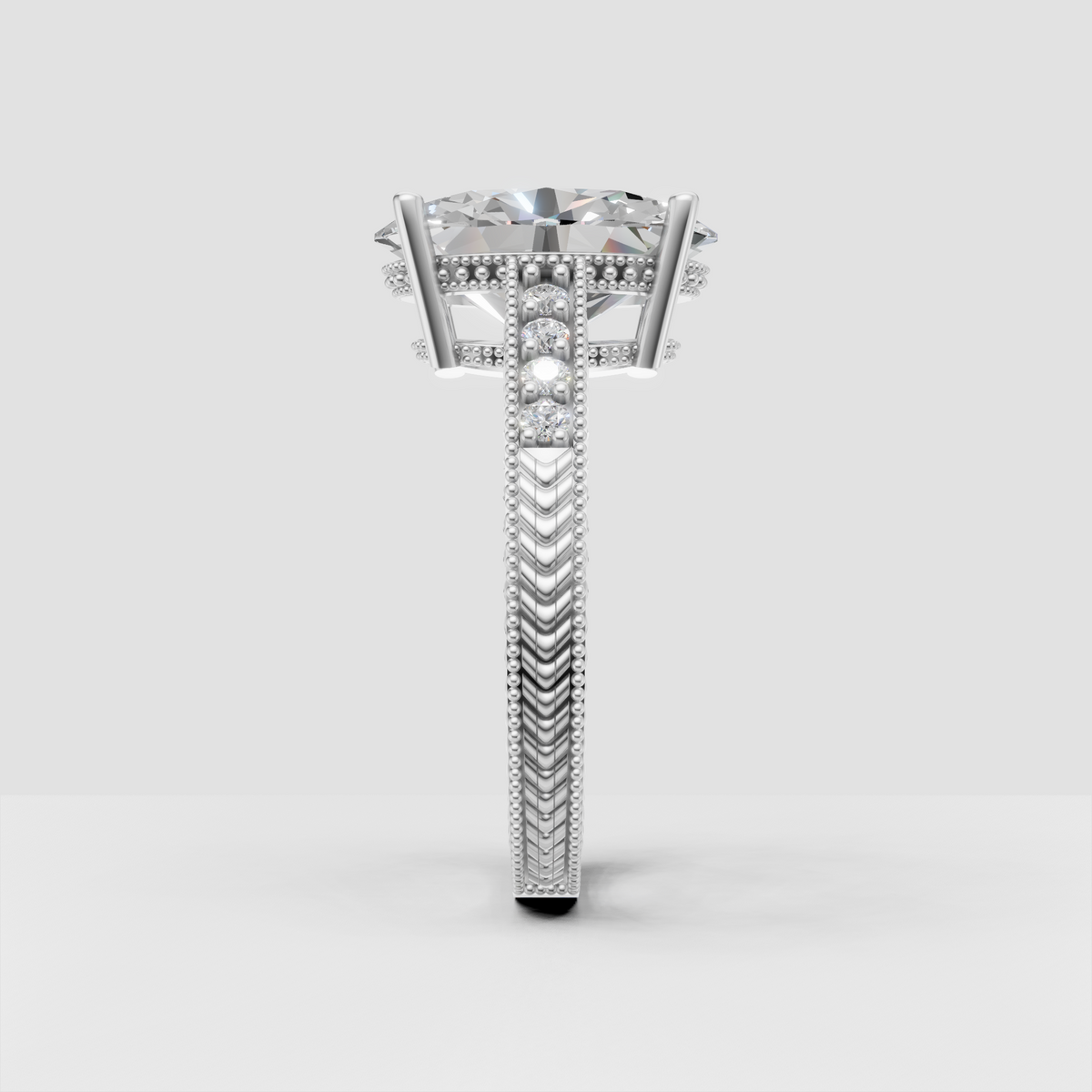 Oval diamond ring featuring pavé accent stones and milgrain edges