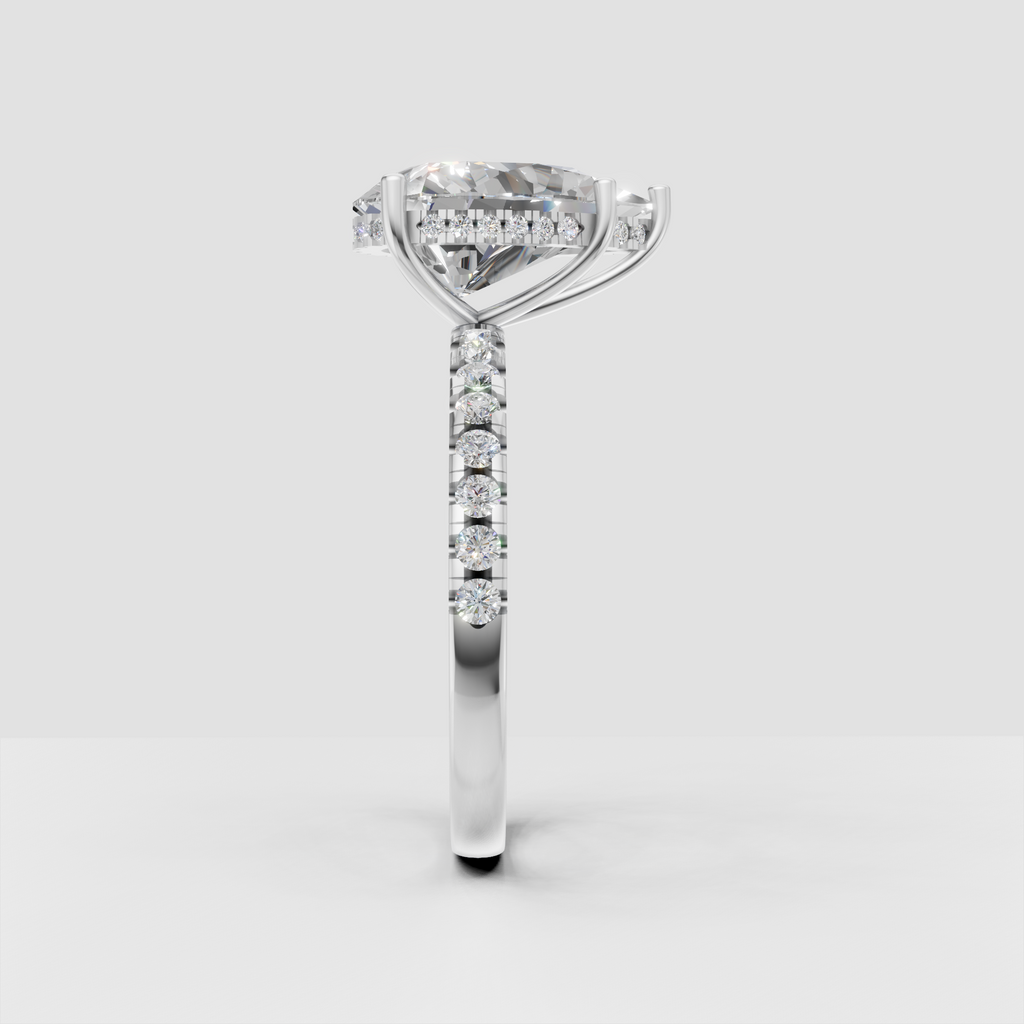 Polished yellow gold engagement ring featuring an elongated pear Diamond center