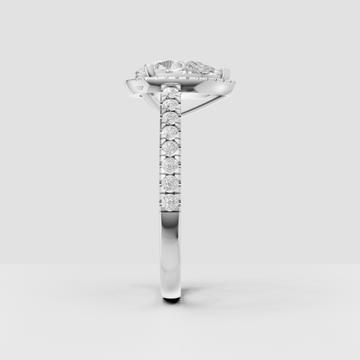 Pear diamond halo ring with brilliant pave-set shoulder stones