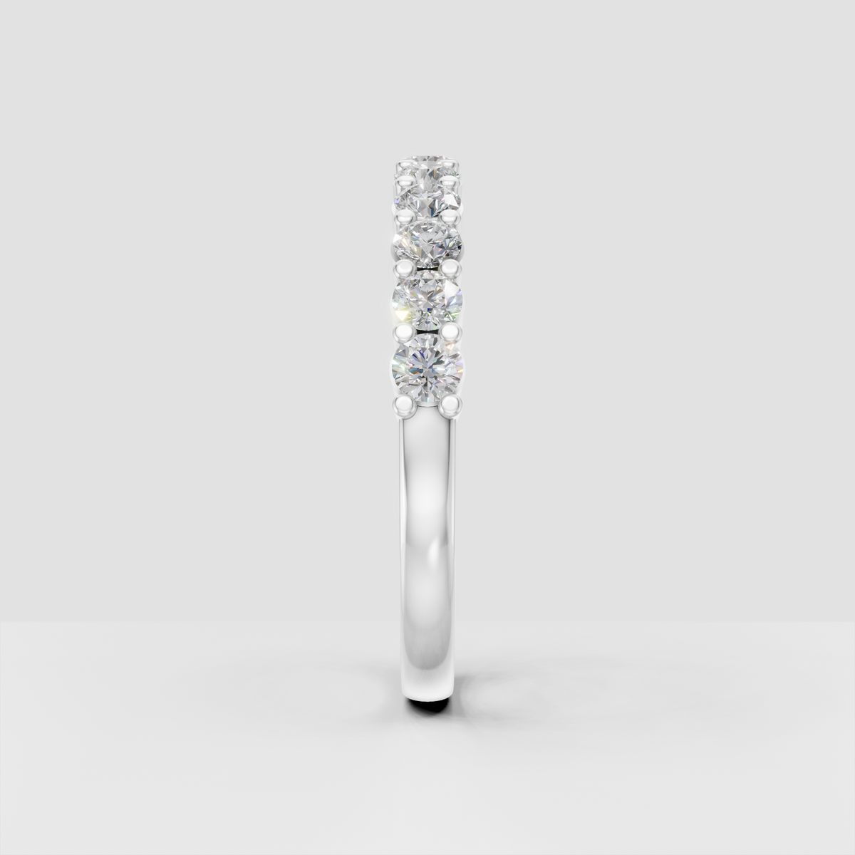 Bead-set round diamond eternity ring with polished gold interior shank