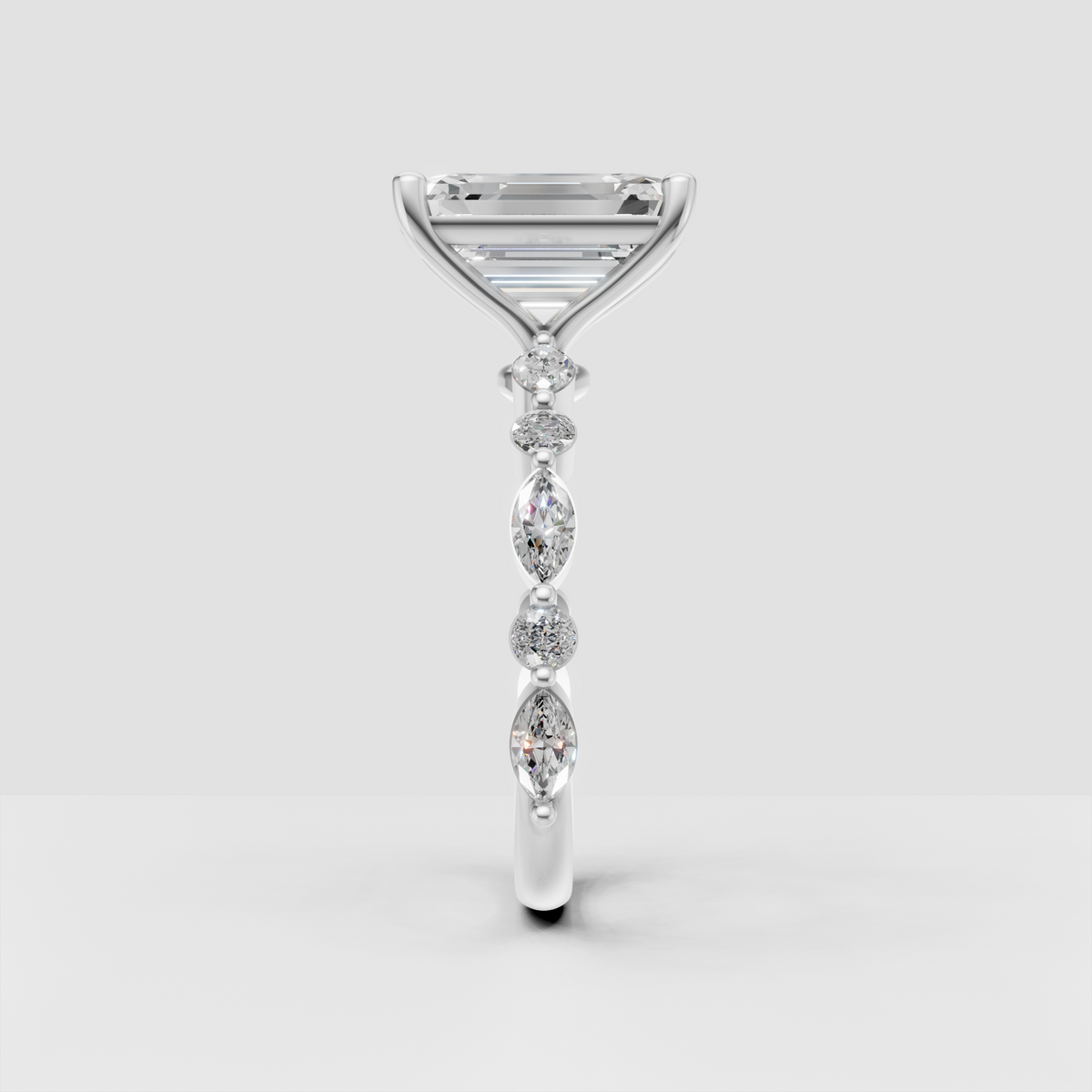 Emerald cut diamond ring featuring alternating pear and round side stones
