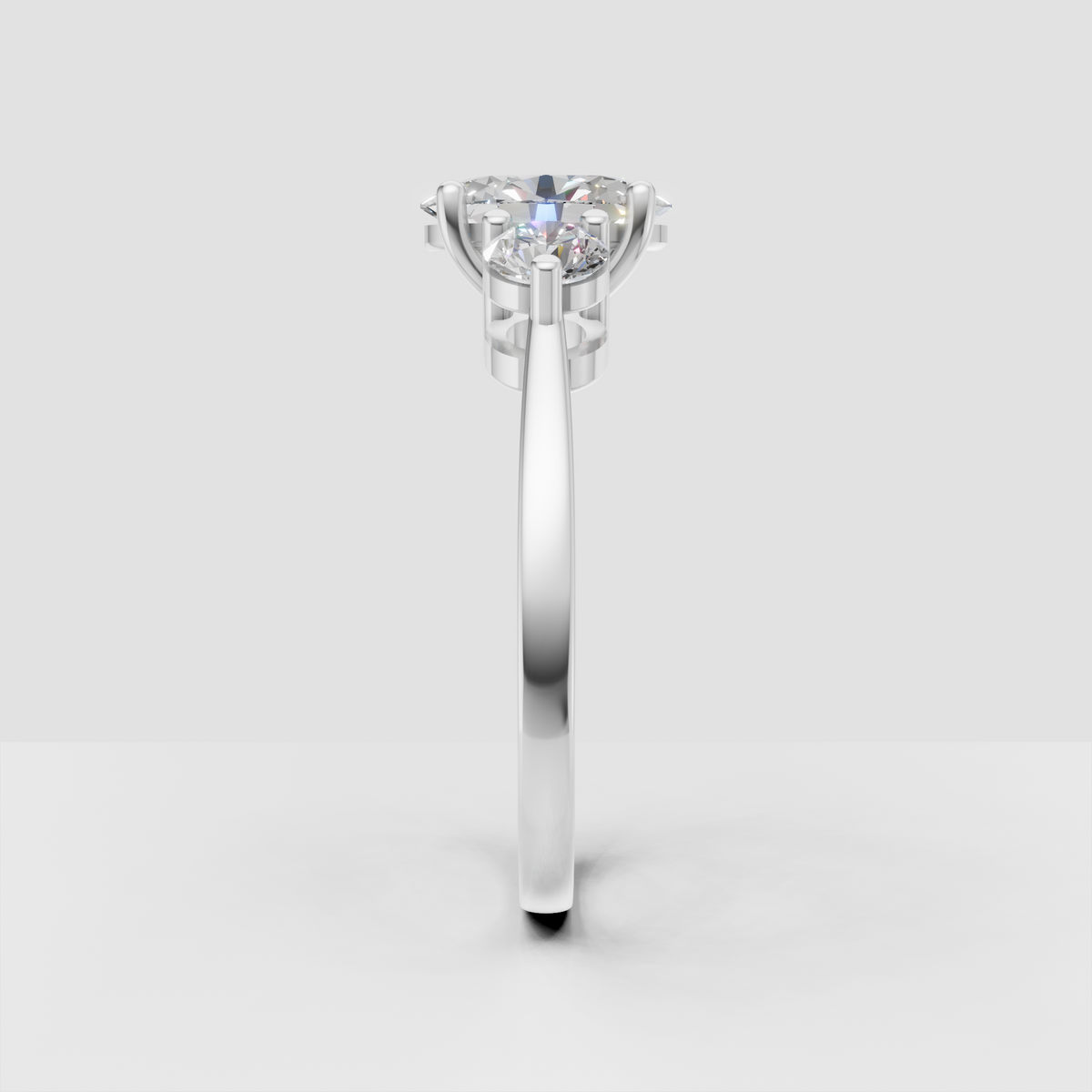 Oval diamond ring featuring round side stones and beaded borders