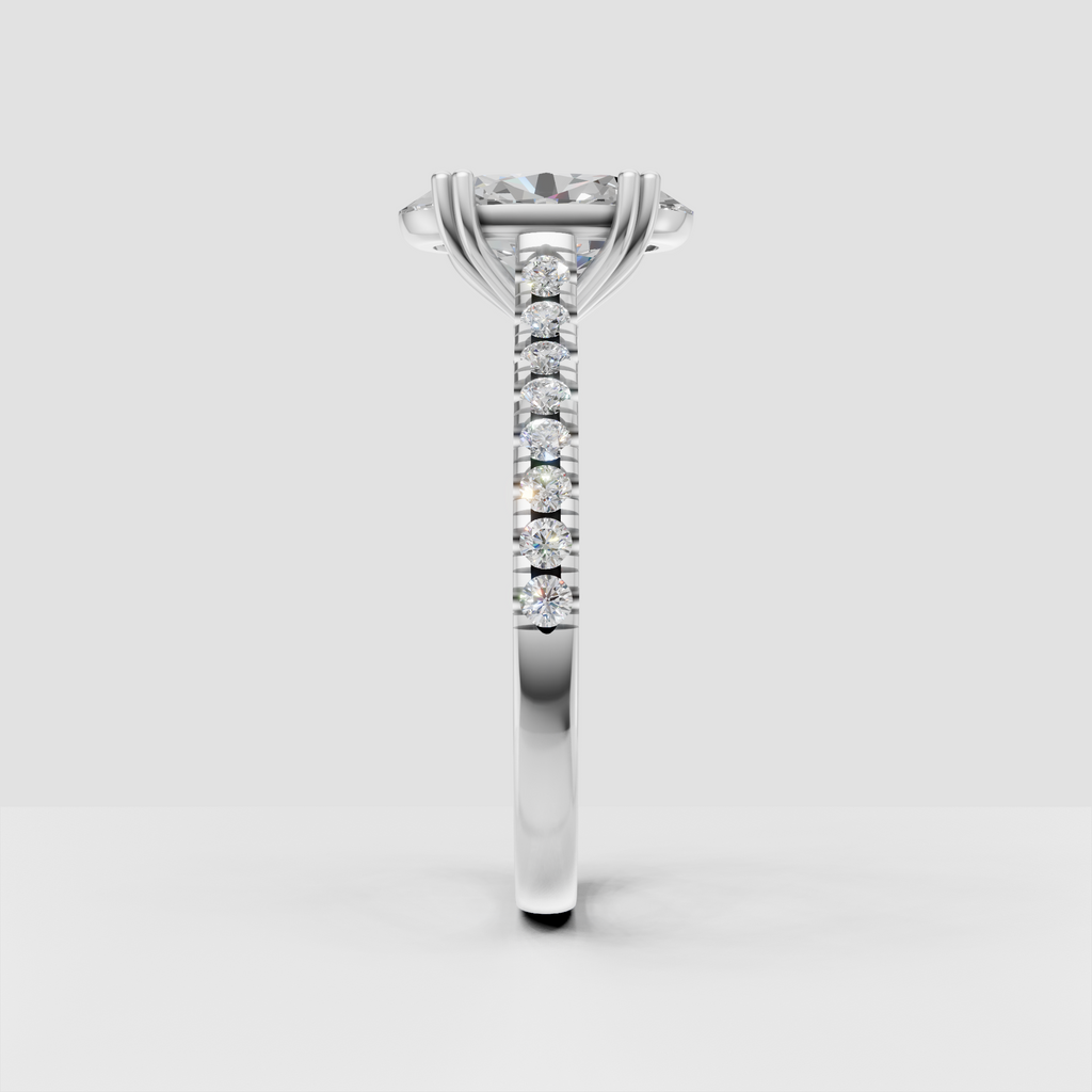 Four-prong oval diamond engagement ring with continuous side stone detailing