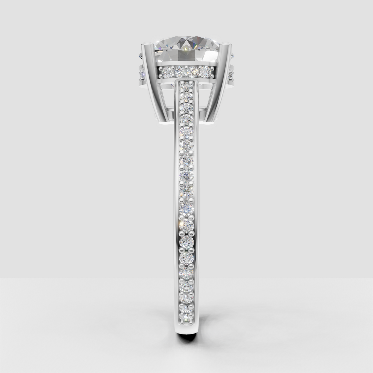 Round center diamond ring featuring four prongs and continuous pavé sparkle.