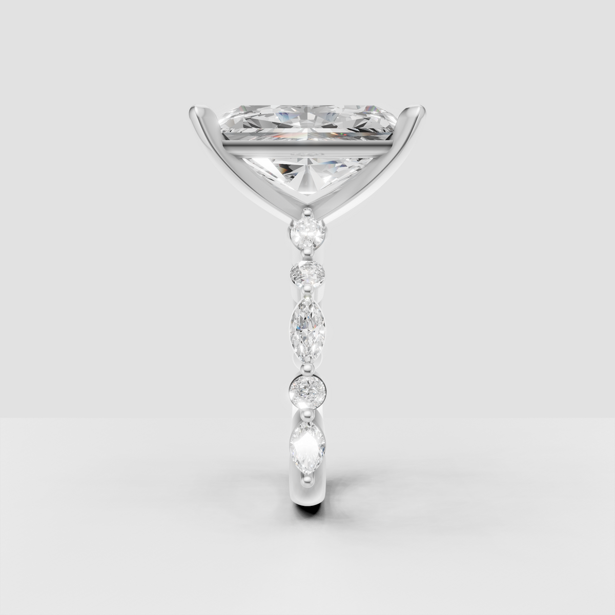 Radiant cut center diamond ring with round and marquise shoulder stones