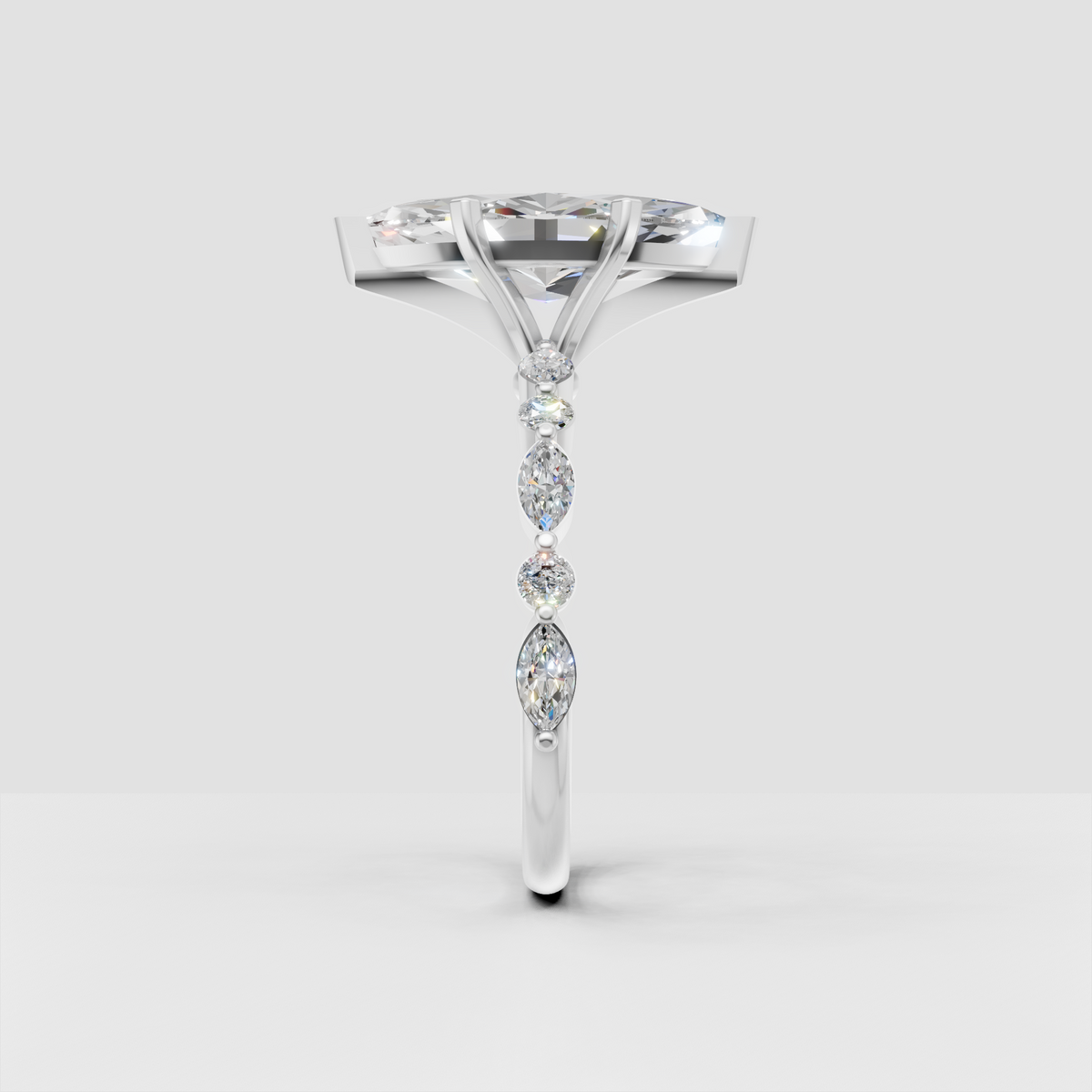 White gold marquise diamond solitaire ring with round and marquise side stones.