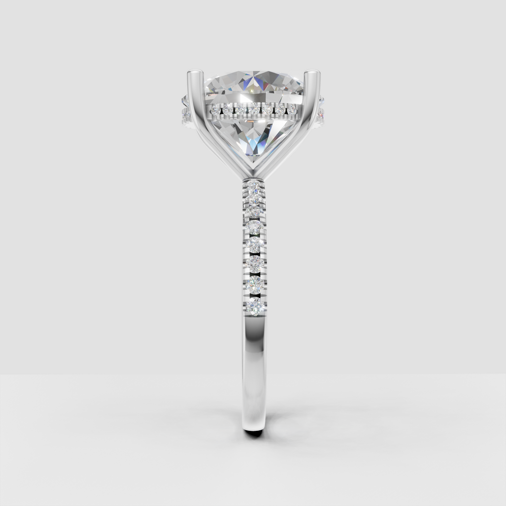 Luxury round diamond engagement ring featuring a hidden halo and pavé-set accent stones.
