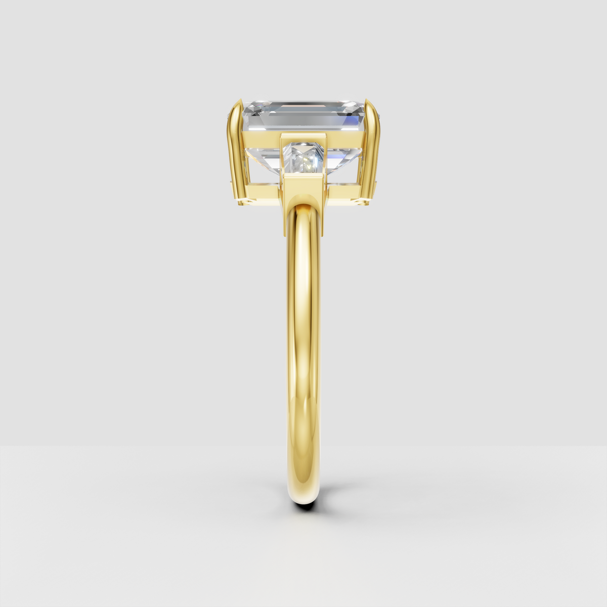 Three stone emerald cut diamond ring with baguette side stones for engagement