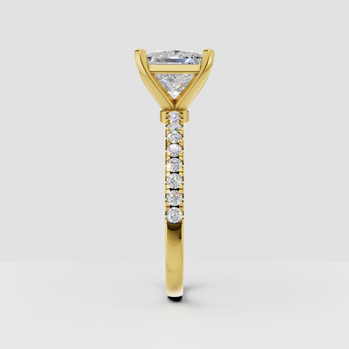 Yellow gold princess cut diamond solitaire with shoulder accent stones