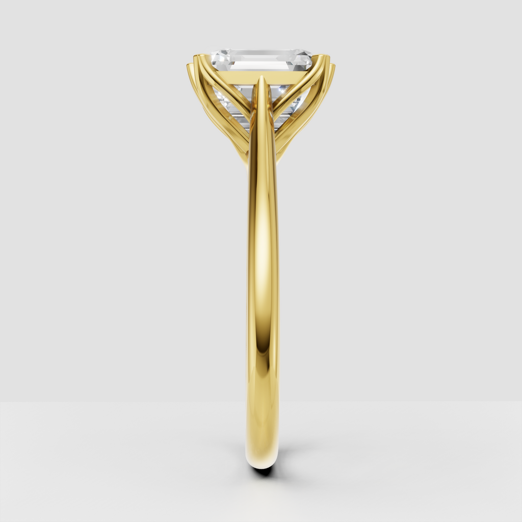 Yellow gold emerald cut diamond ring with elegant prong setting