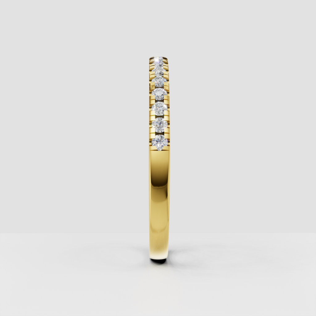Polished yellow gold ring featuring a row of round brilliant diamonds