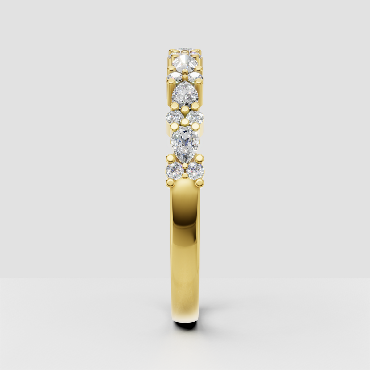 Yellow gold pear and round diamond ring