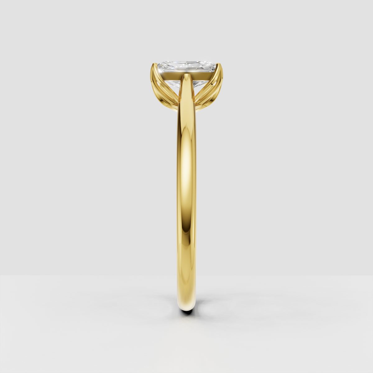 Yellow gold radiant cut solitaire ring with claw prong setting