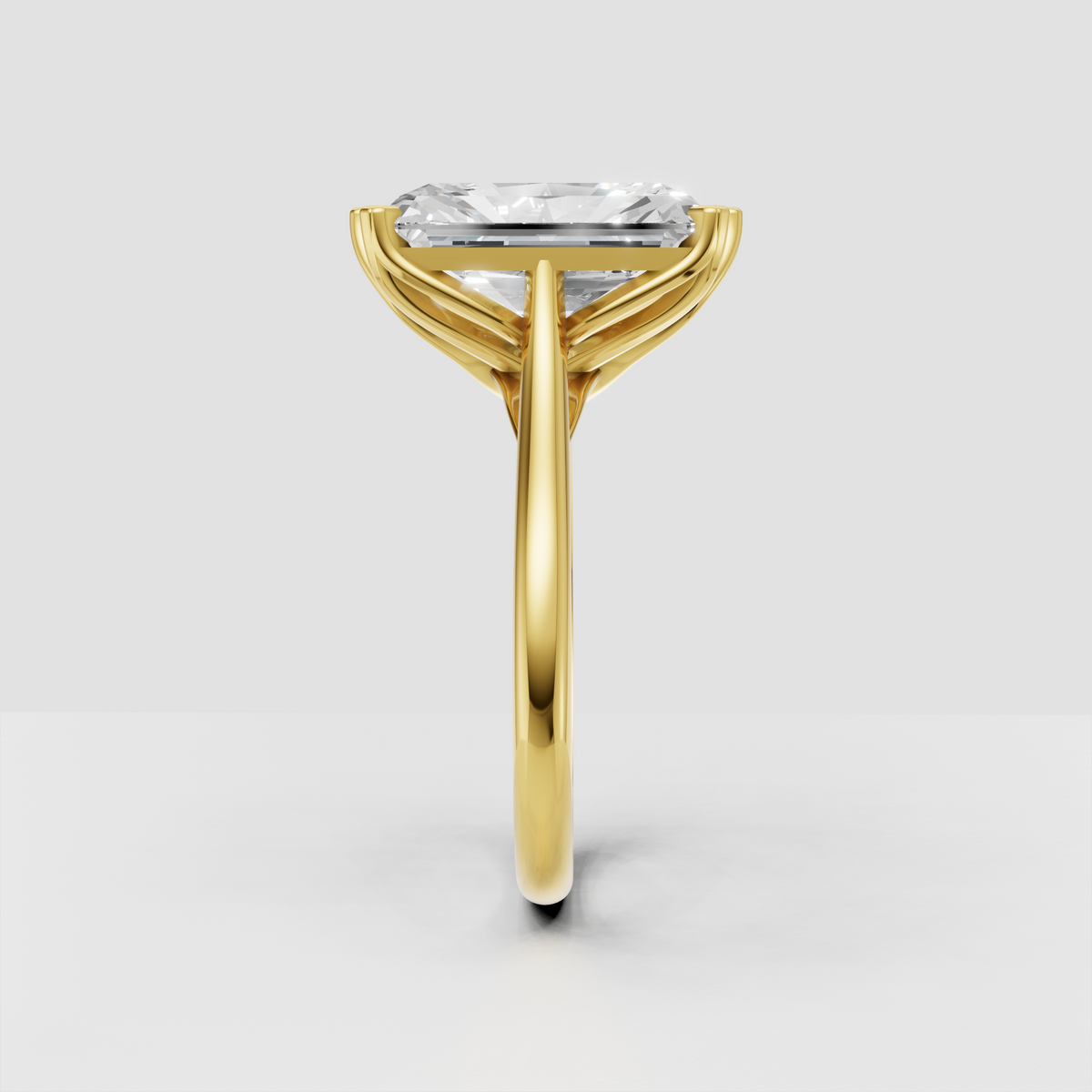 Rectangular radiant diamond ring with elegant yellow gold prong setting