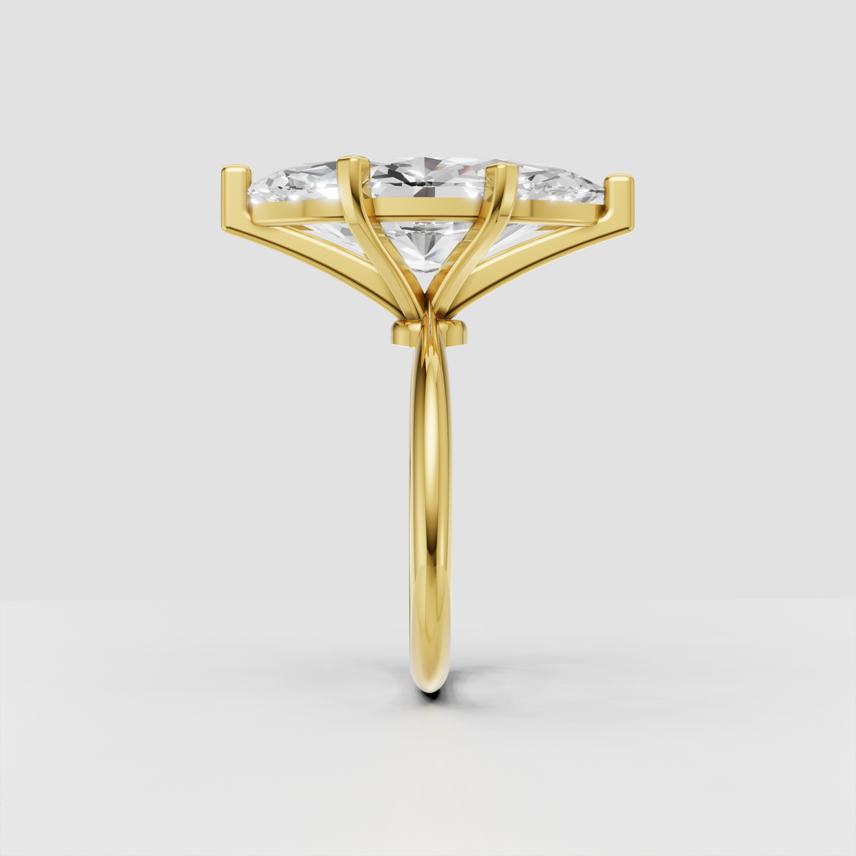 Elongated marquise diamond solitaire ring with yellow gold band