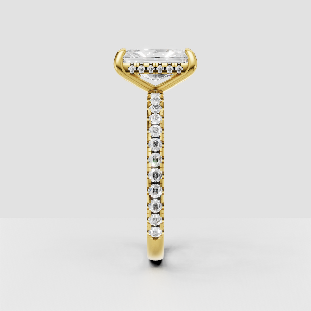 Radiant cut diamond ring featuring delicate pave-set band