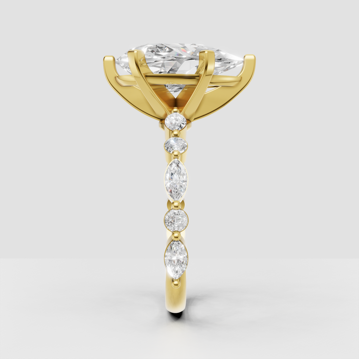 Yellow gold pear cut engagement ring with marquise accents