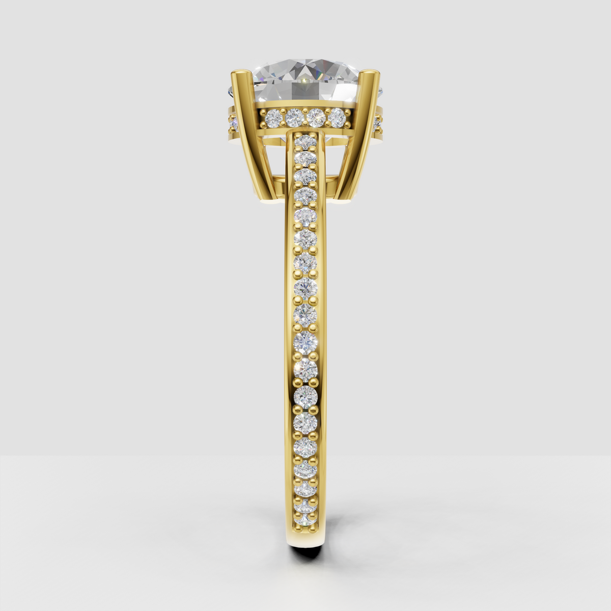 Round diamond solitaire ring with four rounded prongs and sparkling side stones.