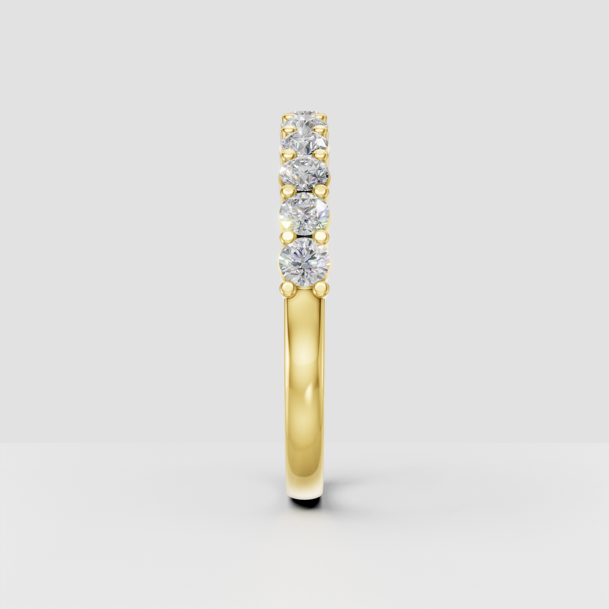 Half eternity diamond band with round brilliant-cut stones and gold bead prongs