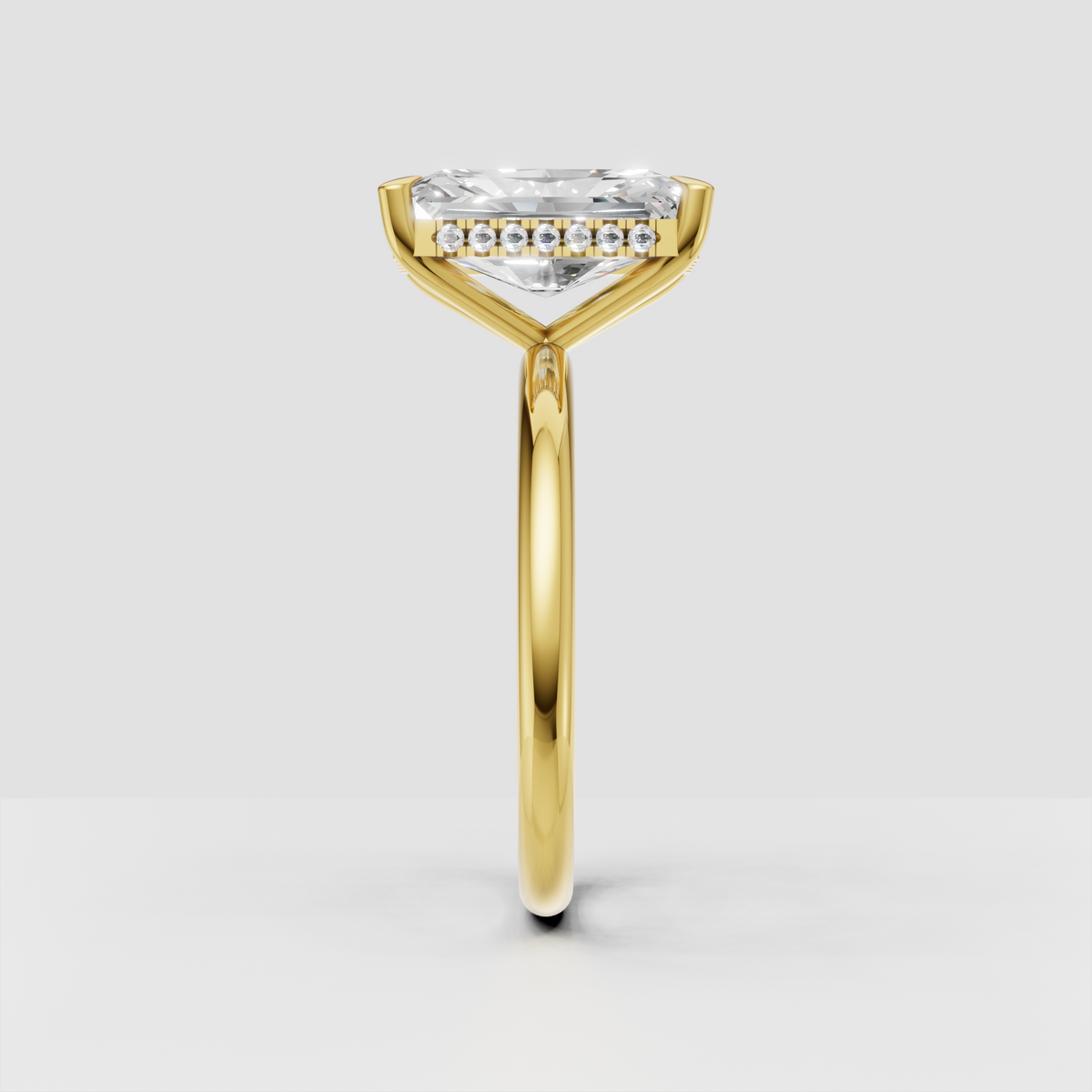 Elongated radiant diamond engagement ring with hidden halo