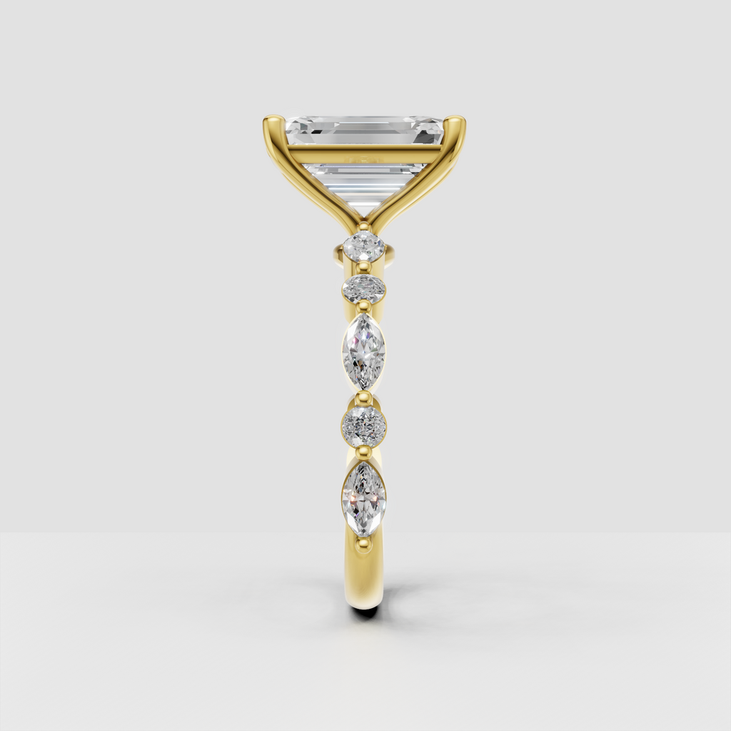 Yellow gold emerald cut ring with pear and round accent stones
