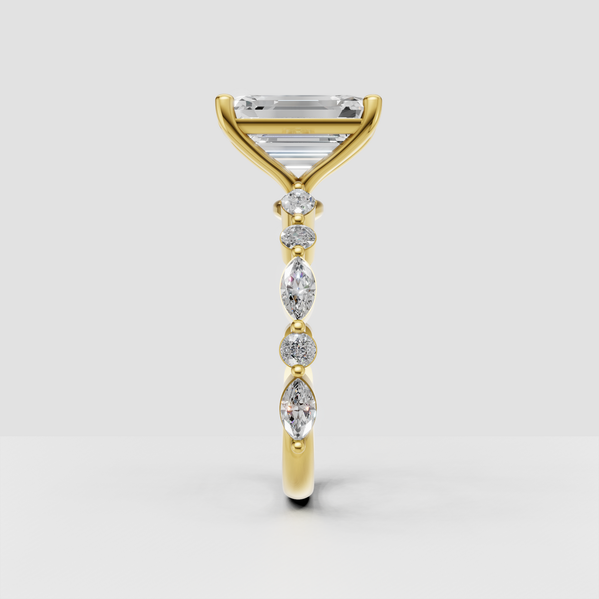 Yellow gold emerald cut ring with pear and round accent stones