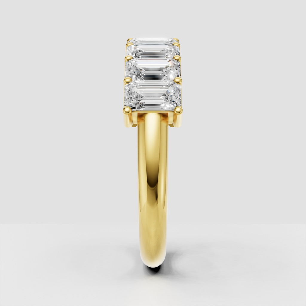 Yellow gold emerald cut eternity ring with elongated stones