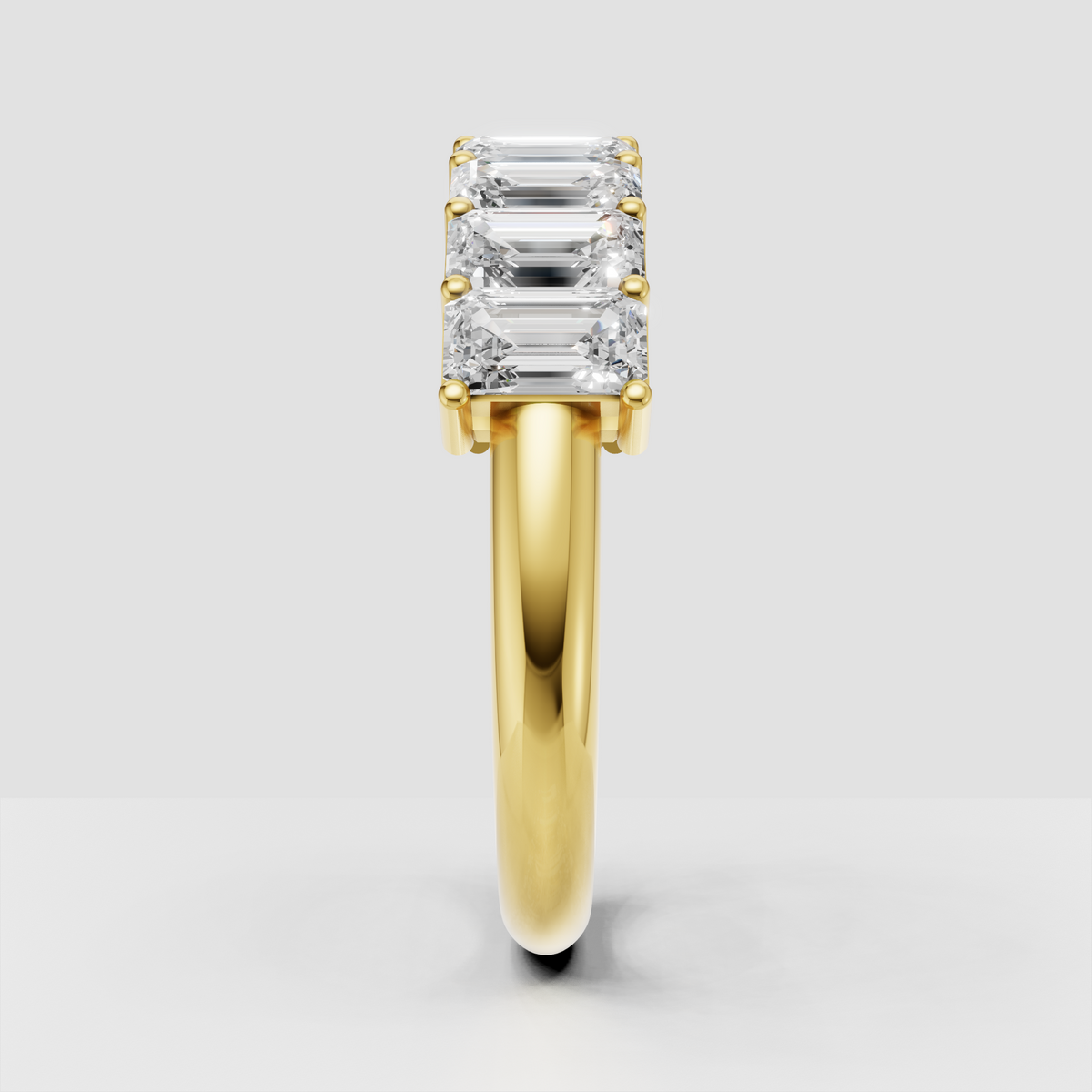 Yellow gold emerald cut eternity ring with elongated stones