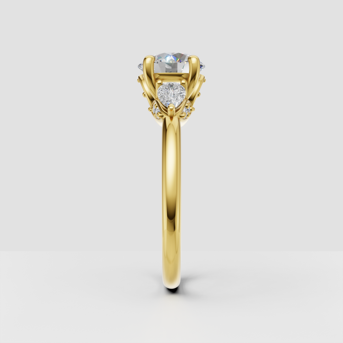 Yellow gold three stone ring with elevated round diamond center