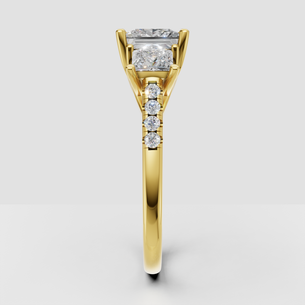 Three-stone princess diamond ring with pave accent band in yellow gold