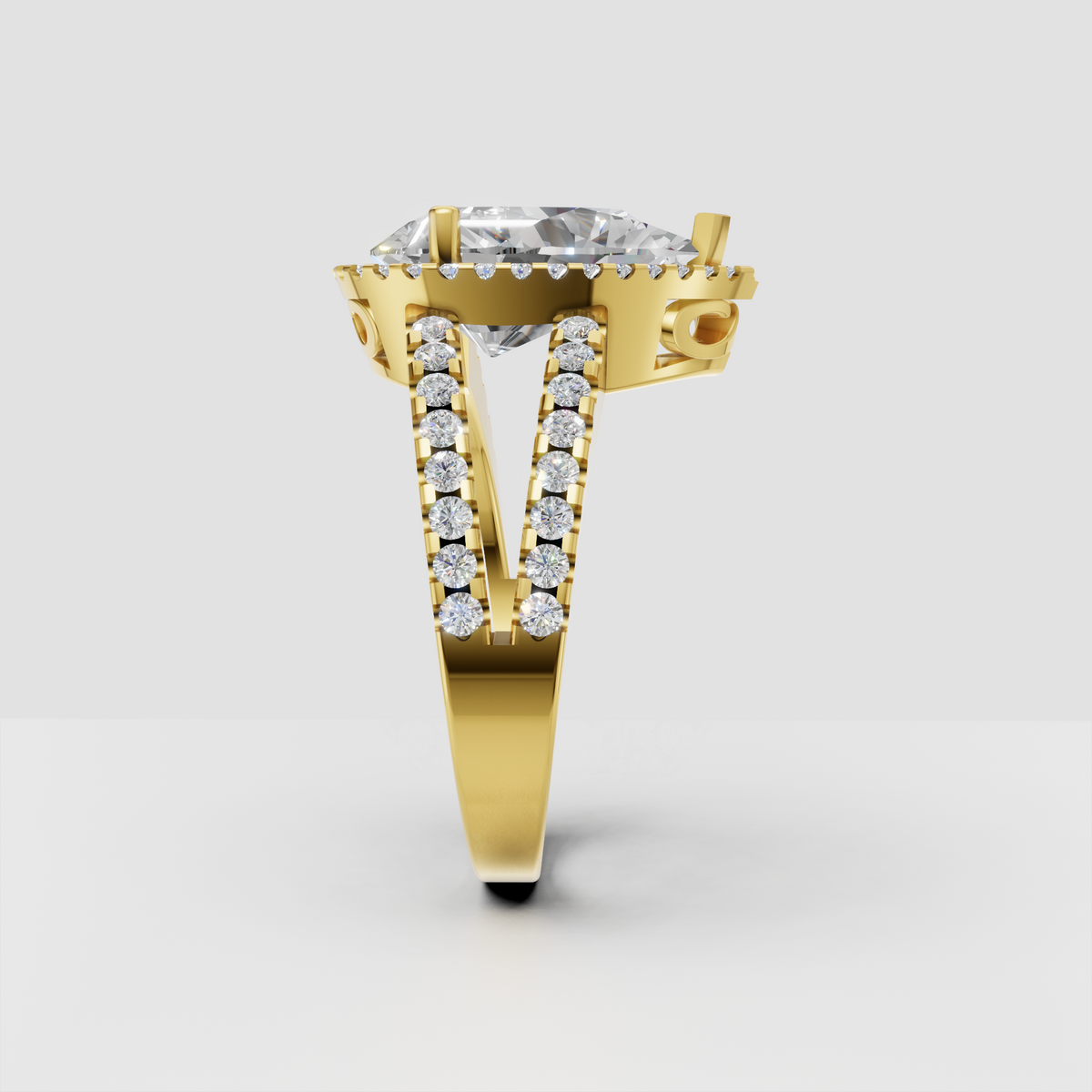 Pear cut diamond ring with round diamond halo and pavé shoulders