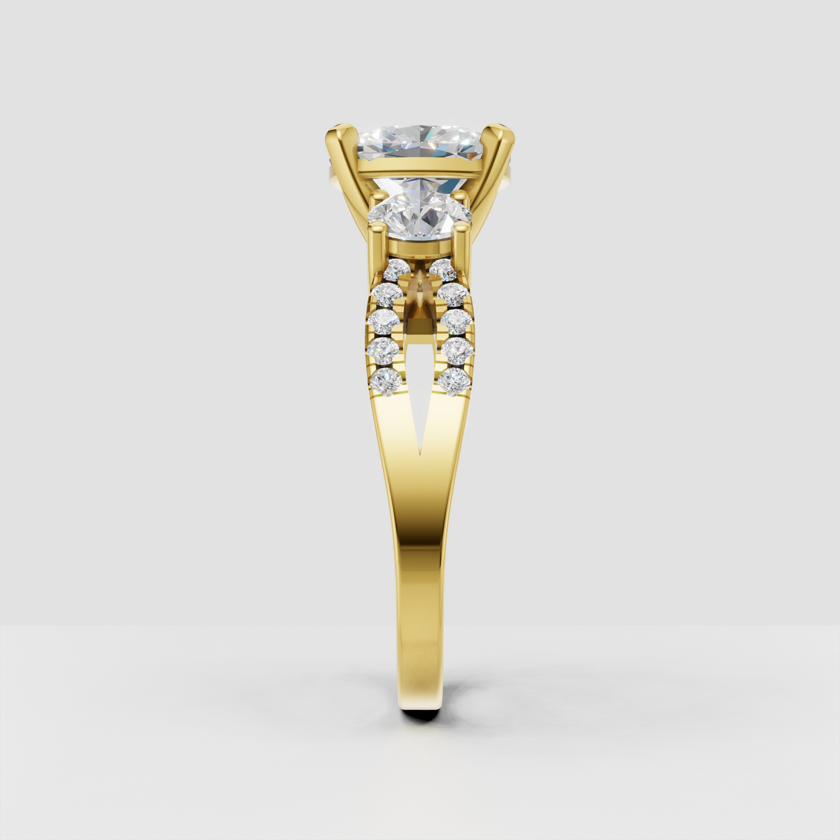 Three stone oval diamond engagement ring with yellow gold setting