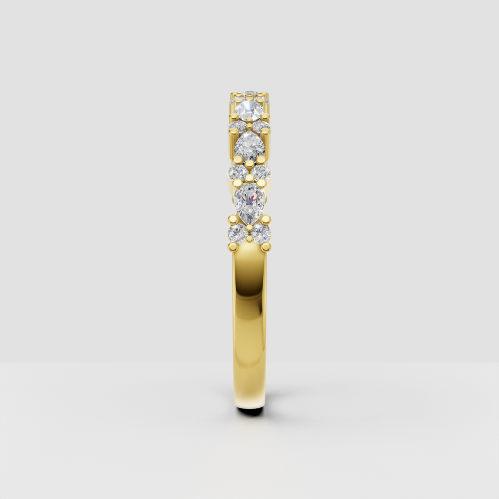 Alternating round and pear cut diamond wedding band with prong setting