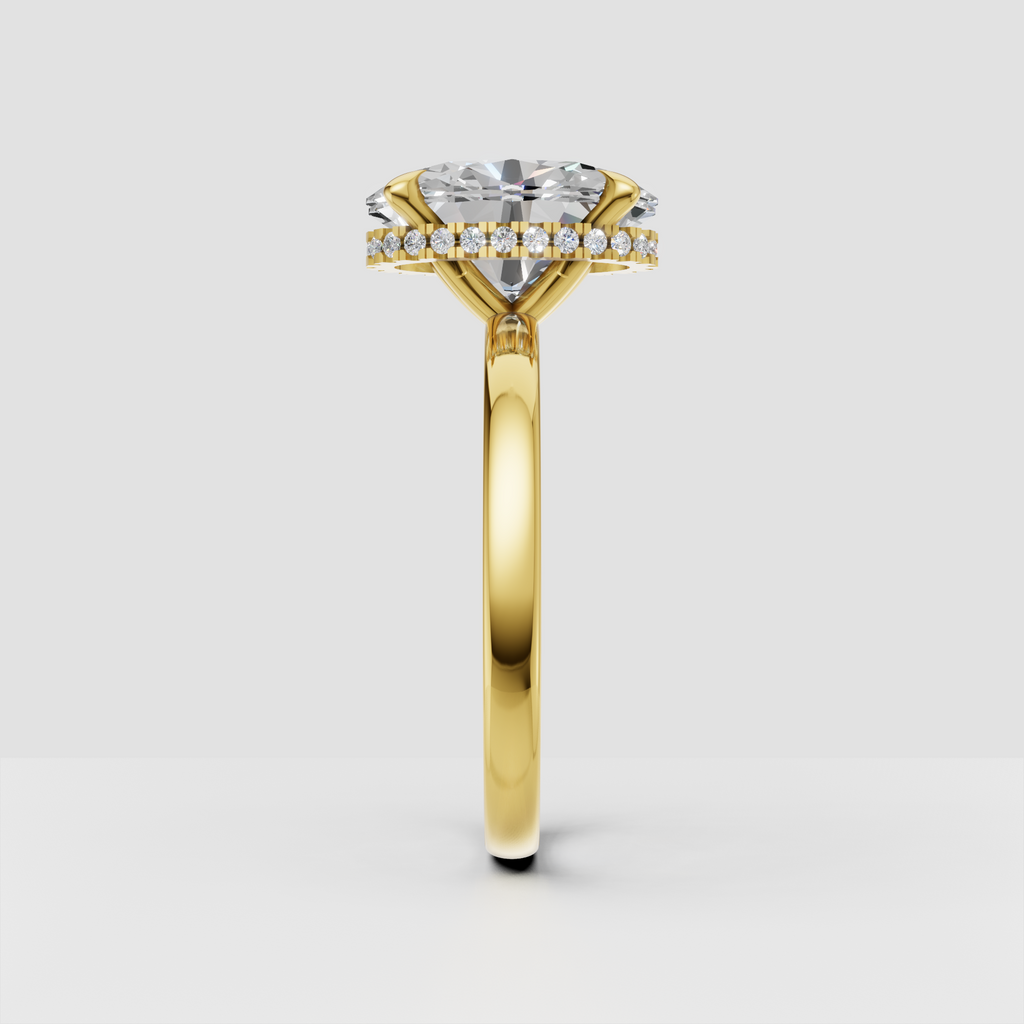 Yellow gold oval engagement ring with hidden diamond halo