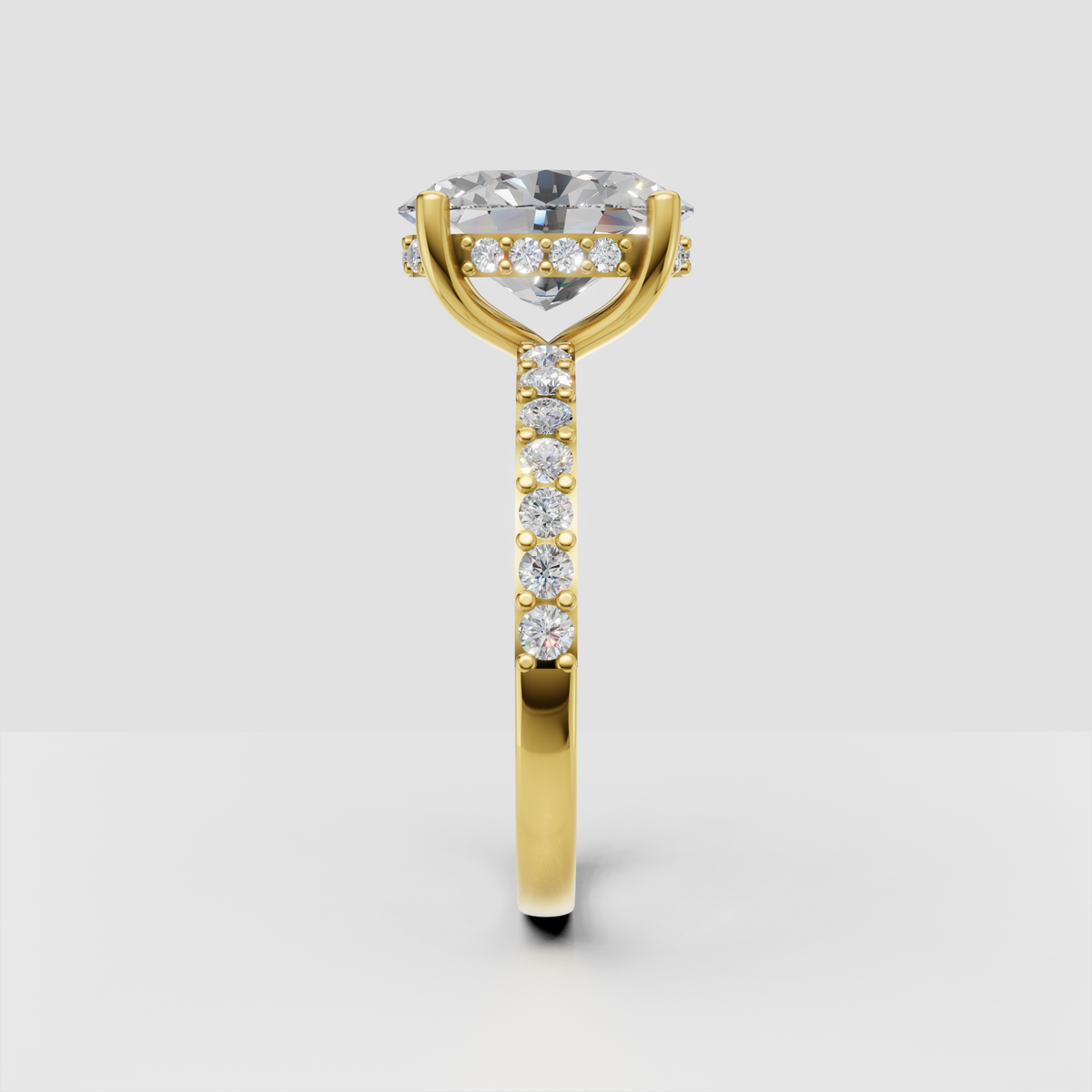 Oval cut hidden halo ring featuring a delicate pavé band