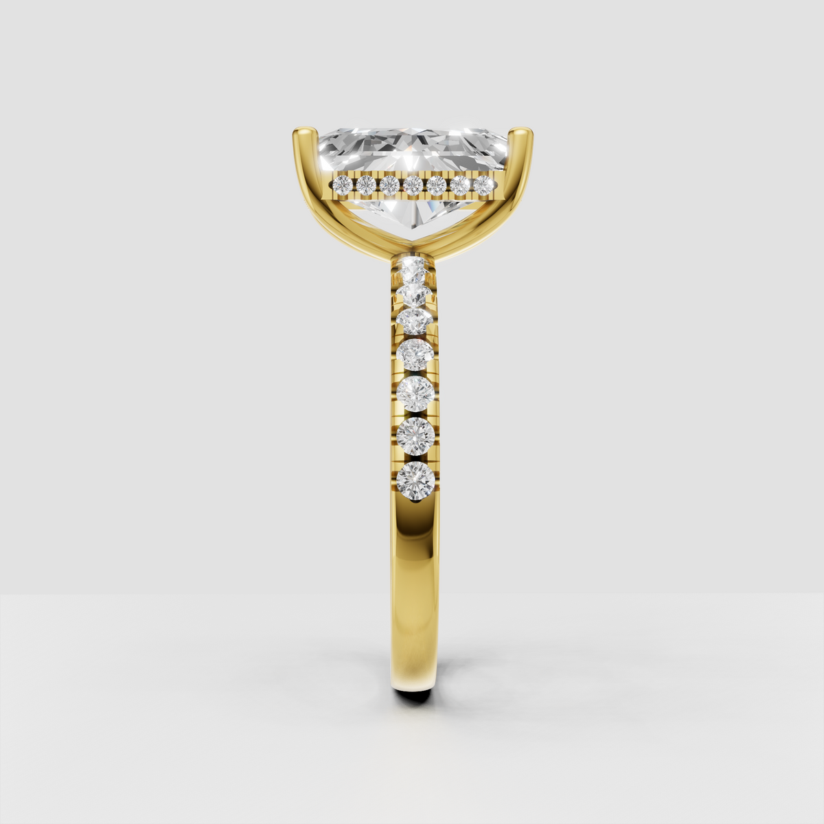 Yellow gold radiant diamond engagement ring with pavé band