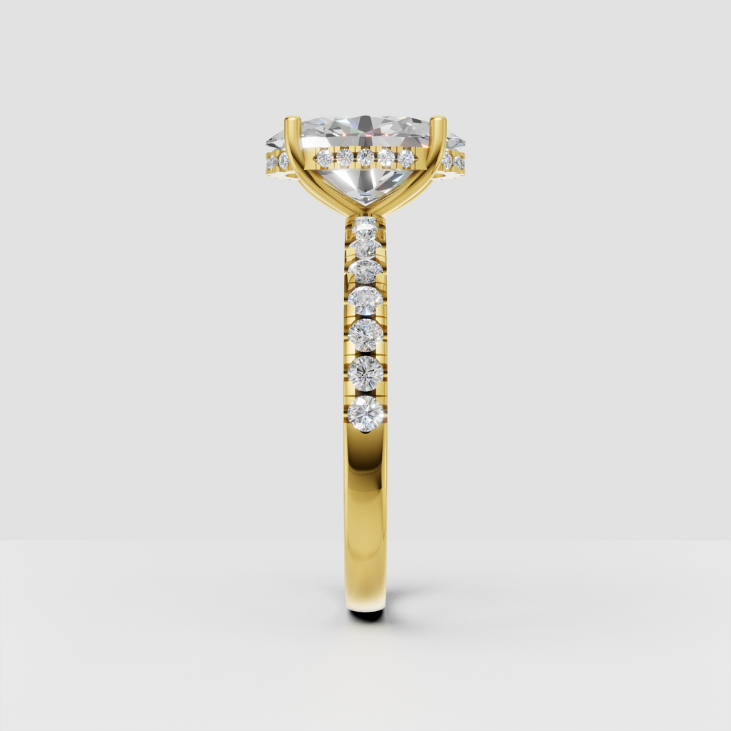Yellow gold pear cut diamond ring featuring a cathedral-inspired setting