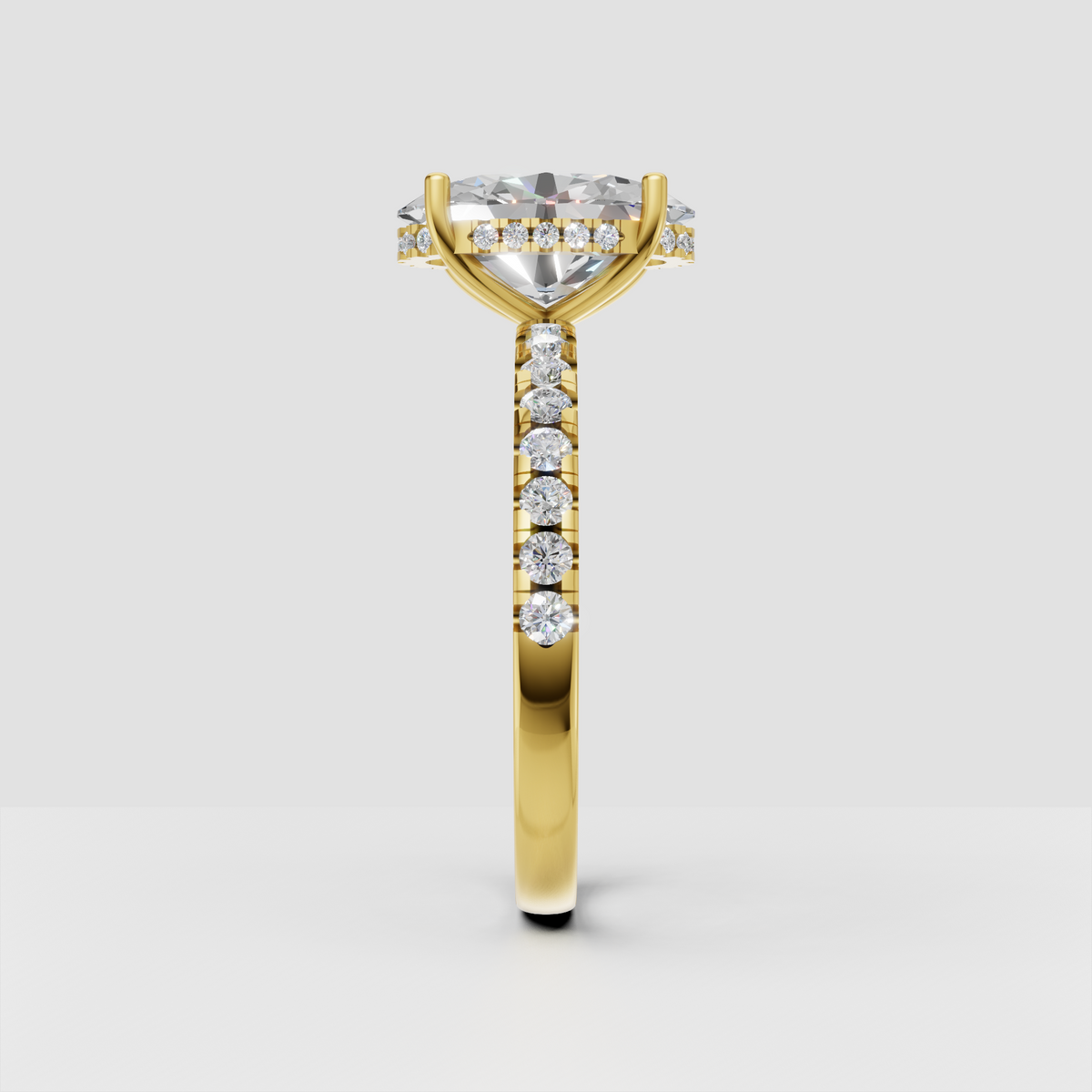 Yellow gold pear cut diamond ring featuring a cathedral-inspired setting