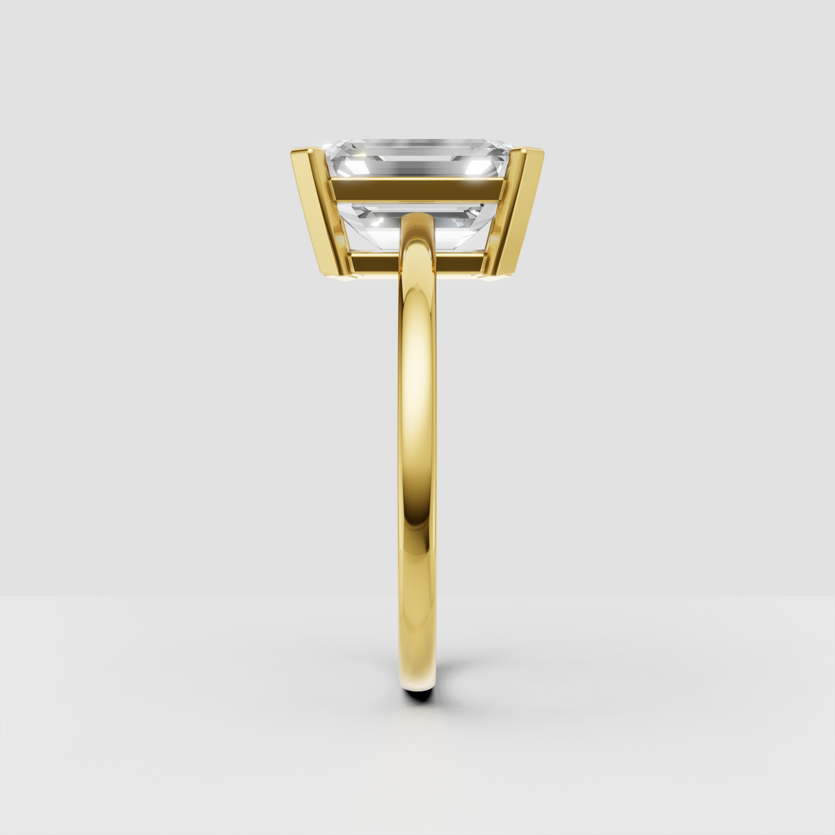Emerald diamond solitaire ring in yellow gold