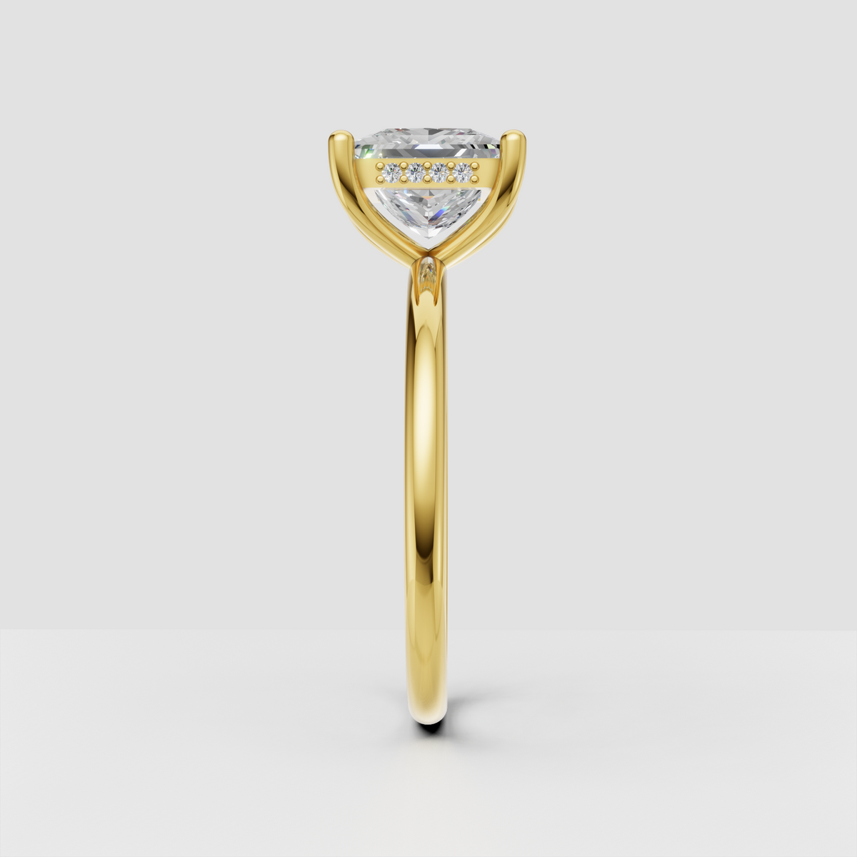 Yellow gold princess cut diamond solitaire engagement ring with delicate accent diamonds underneath