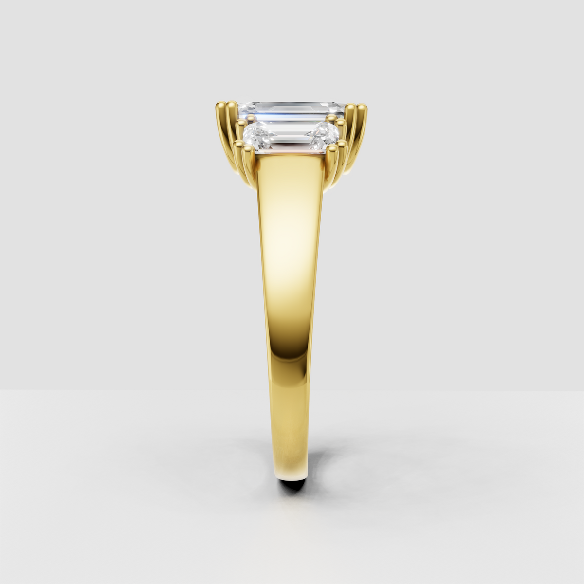 Polished band emerald cut three stone engagement ring