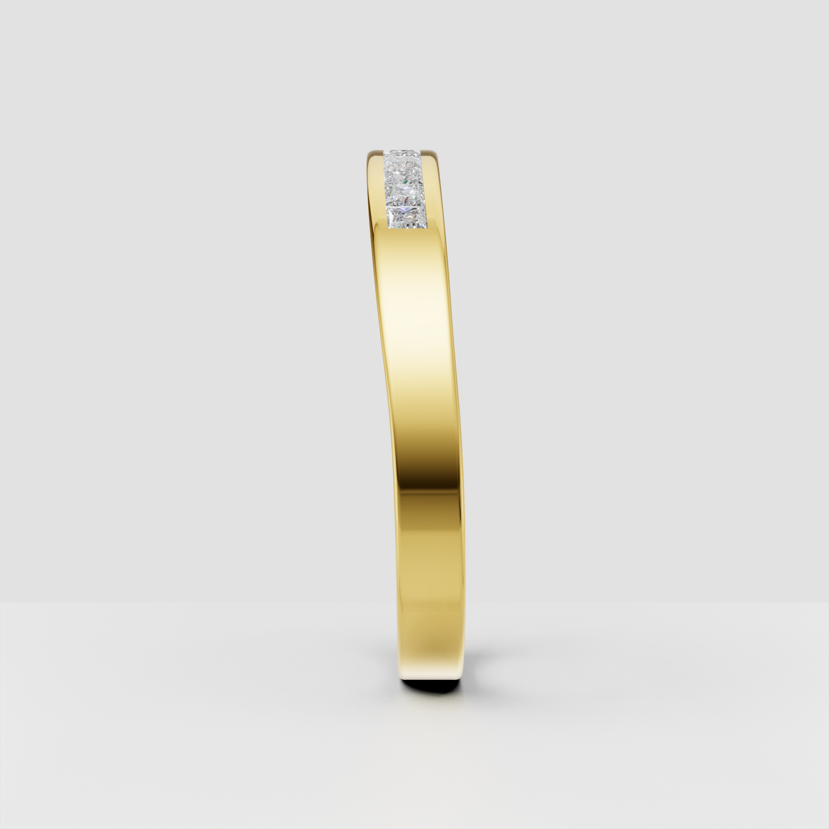 Polished gold wedding ring featuring a row of square-cut accent stones