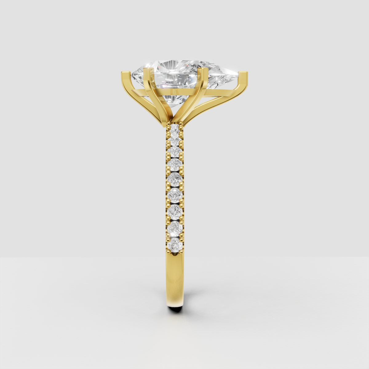 Yellow gold pear cut engagement ring with sparkling side stones