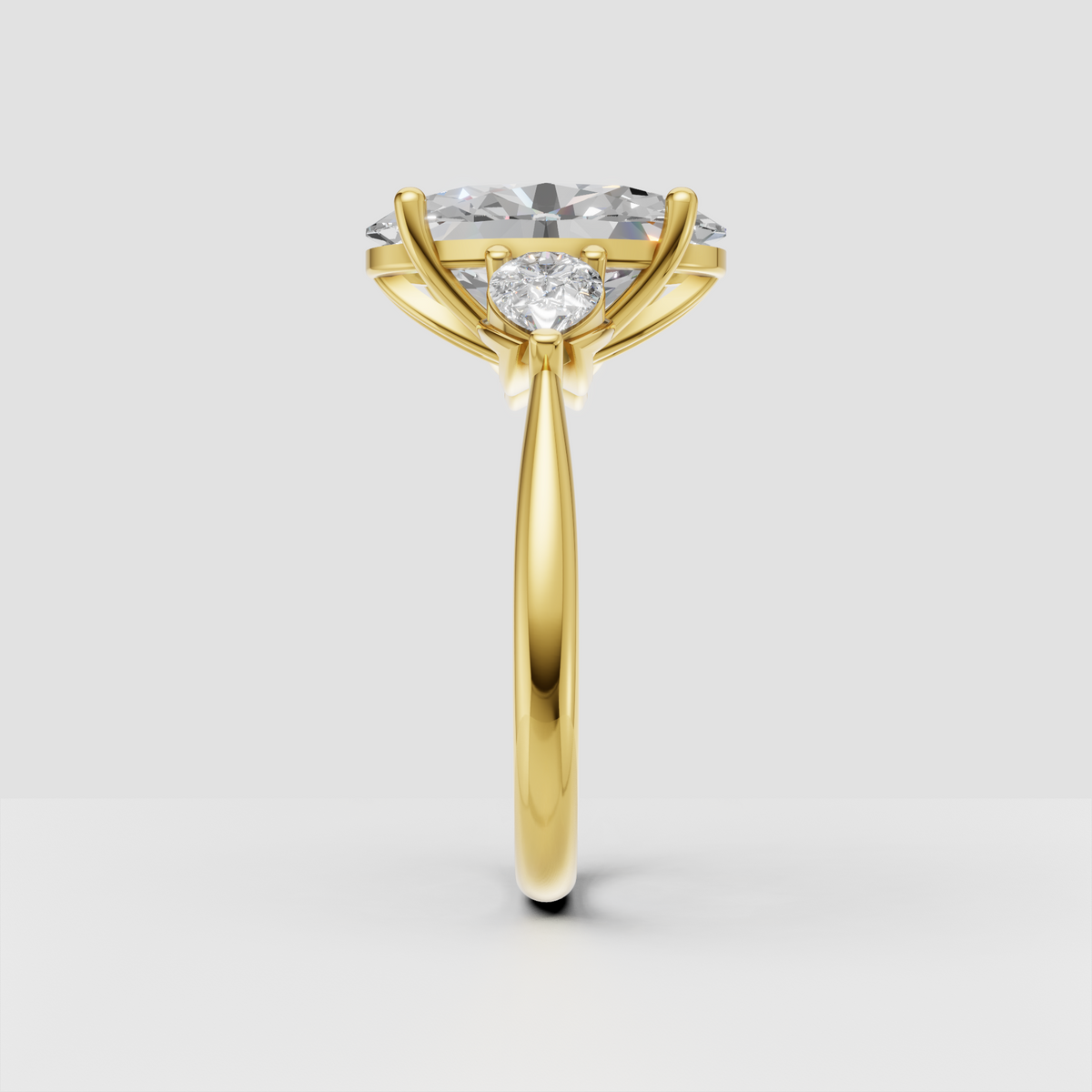 Yellow gold oval diamond ring featuring two marquise side stones and an open gallery
