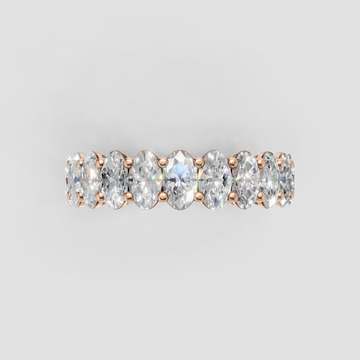 Yellow gold eternity ring with aligned oval diamonds
