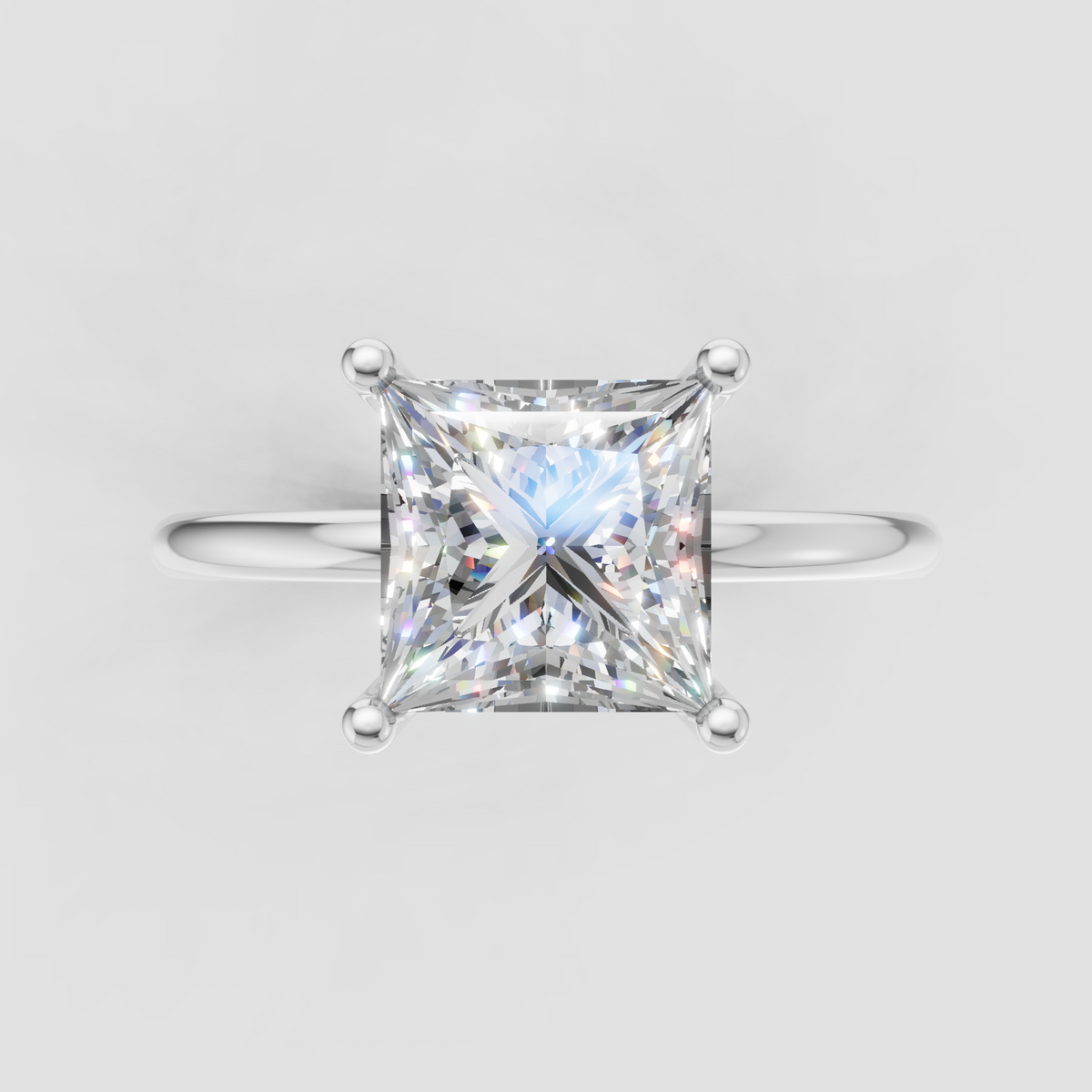 Classic princess cut diamond solitaire ring in yellow gold with a refined four-prong setting and polished band