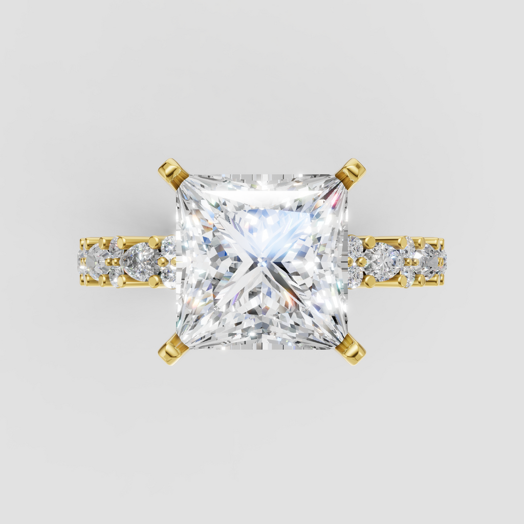 Princess cut diamond four-prong engagement ring with yellow gold band and side stones